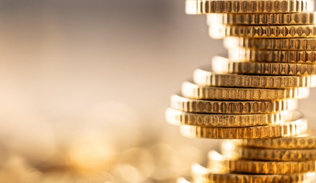 Golden Euro coins built in the shape of a tower that balances before falling, a symbol of financial growth and fall 