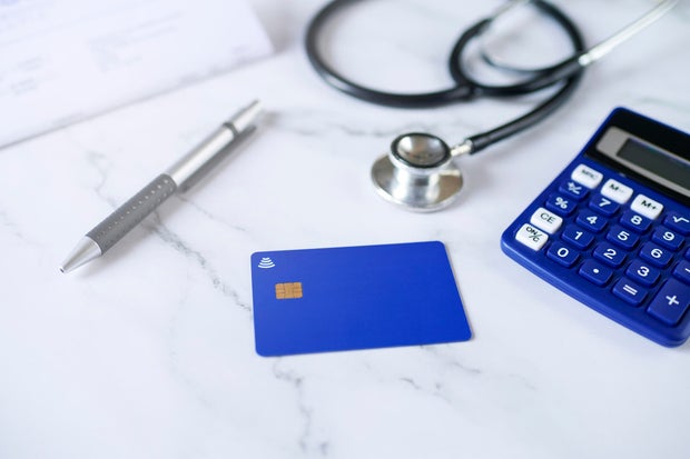 Blue credit card next to stenoscope and calculator 