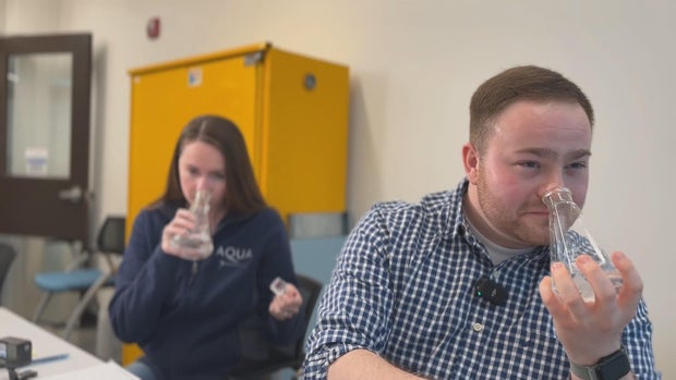 Aqua employees testing water samples based on taste and smell 