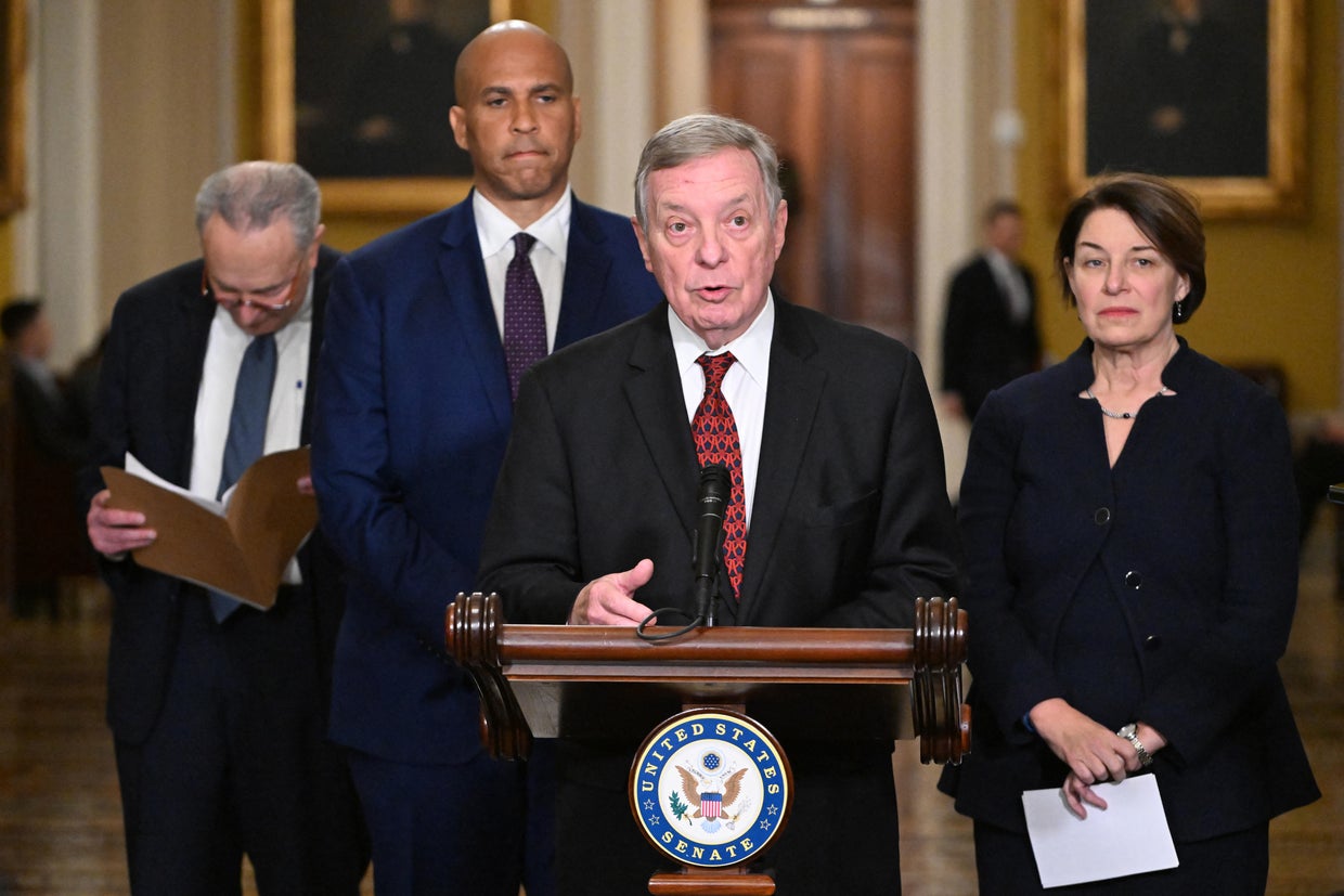 Democratic Whip Dick Durbin speaks to reporters flanked by (from L) Leader Chuck Schumer, Sen. Cory Booker and Sen. Amy Klobuchar, at the Capitol in Washington, D.C., on December 3, 2024.