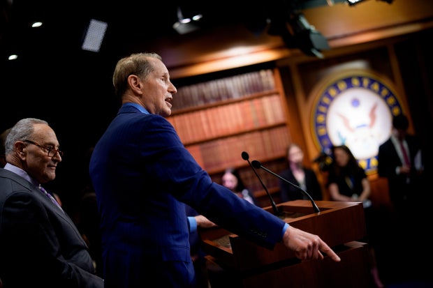 Sen. Ron Wyden, accompanied by Senate Minority Leader Chuck Schumer, speaks at a news conference at the Capitol on March 26, 2025 in Washington, D.C.