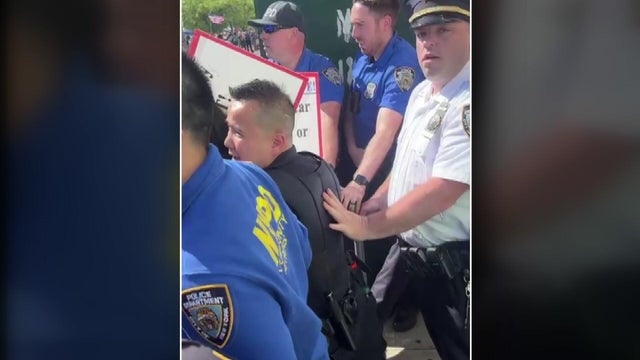 NYPD officers form a line to hold back protesters. 