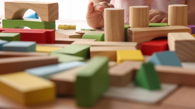 Little girl playing wooden block 