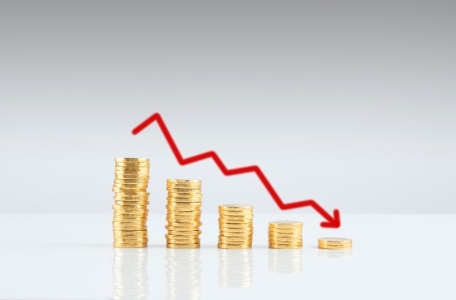 stack of coins and graph down 