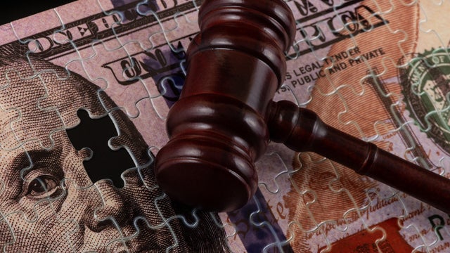 Puzzle in the form of a $100 bill and a judge's gavel 