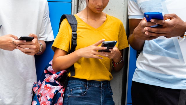 Students using cellphones at school 