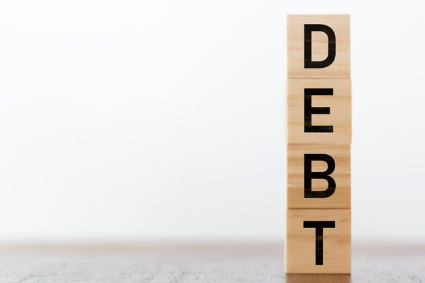 Debt written on wooden box with copy space 