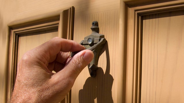 hand on door knocker 