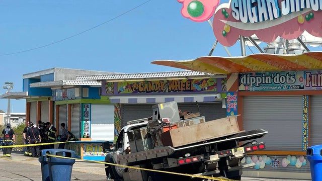 A truck partially fallen through the Wildwood boardwalk 