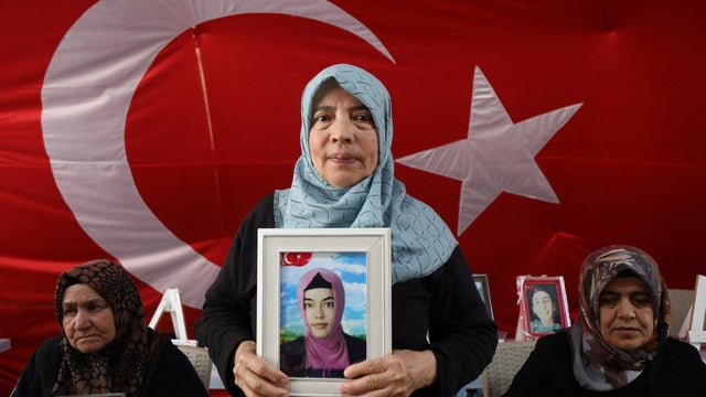 Hatice Levent holds a picture of her daughter Fadime who is believed to have joined the outlawed PKK, during a gathering in Diyarbakir 