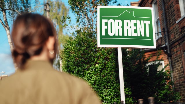 Home for rent with real estate sign 