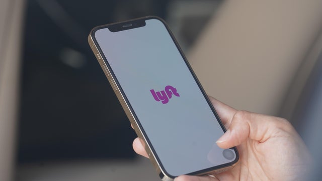 In this photo illustration, A woman browses the Lyft APP on 