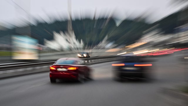 Evening city street racing cars blurred motion 
