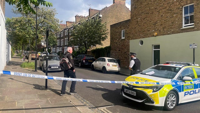 Police survey a cordoned off street, where a fire broke out at Britain's Prime Minister Keir Starmer's home, in north London 