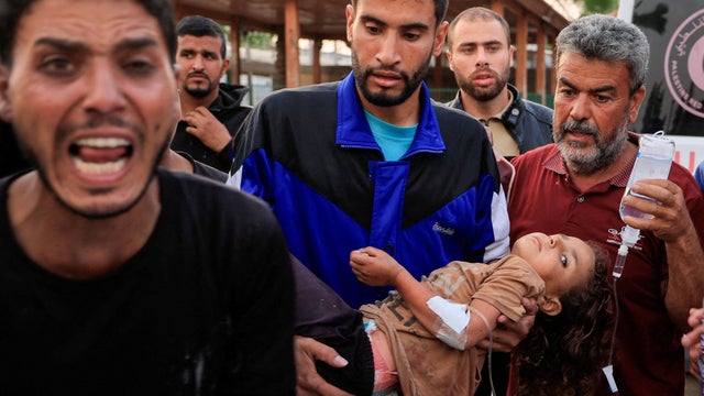 Palestinians inspect the damage at the European Hospital, in Khan Younis 