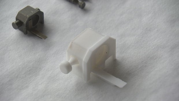 Two switches are shown, both are small, one is made of plastic 