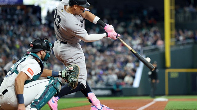 Aaron Judge #99 of the New York Yankees hits a solo home run during the eighth inning against the Seattle Mariners at T-Mobile Park on May 14, 2025 in Seattle, Washington. 