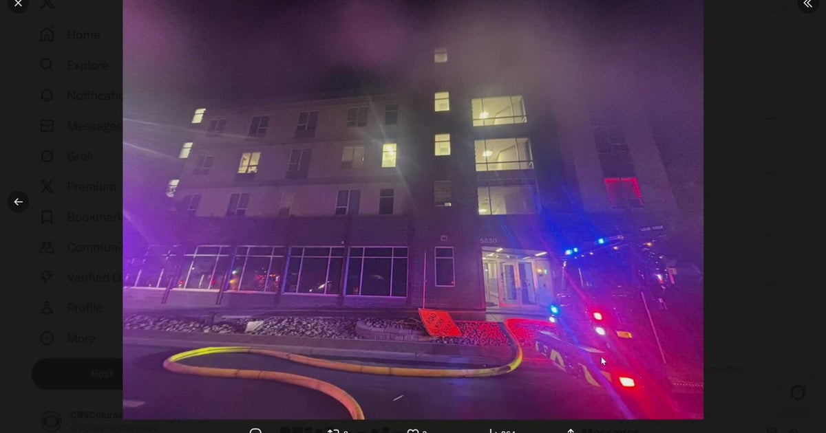 Firefighters rush to put out fire on roof of apartment building - CBS ...