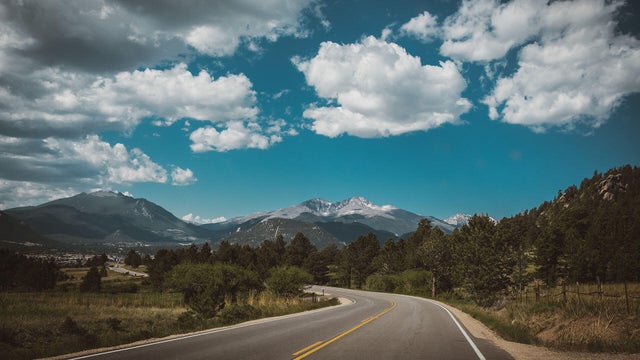 Empty road by mountains against sky,Estes Park,Colorado,United States,USA 