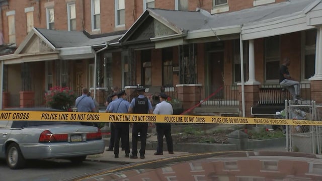 Police tape and police officers are seen on a residential street in Philadelphia 