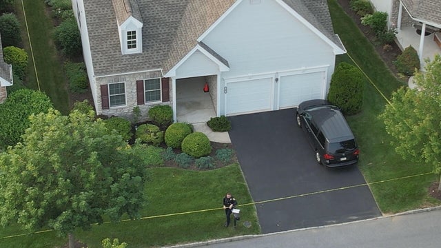 Drone photo of the home, surrounded by police tape, where two people were shot and killed 
