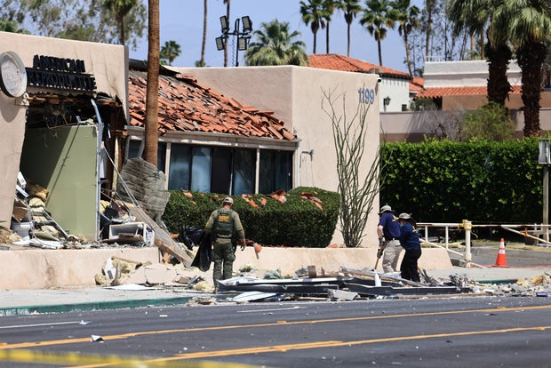 The FBI and other law enforcement personnel gather evidence a day after a bomb exploded near a reproductive health facility in Palm Springs, California, May 18, 2025. 