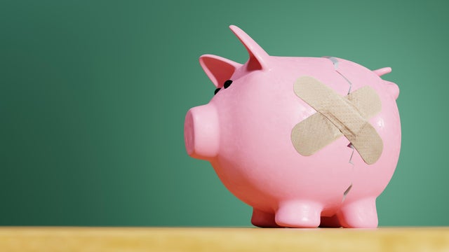 Pink Piggy Bank crack with a band-aid 