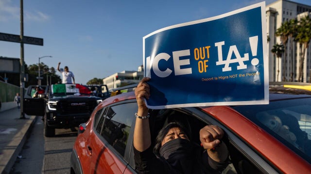 Demonstrators protest outside the Edward R. Roybal Federal Building and the Metropolitan Detention Center in response to ICE raids 
