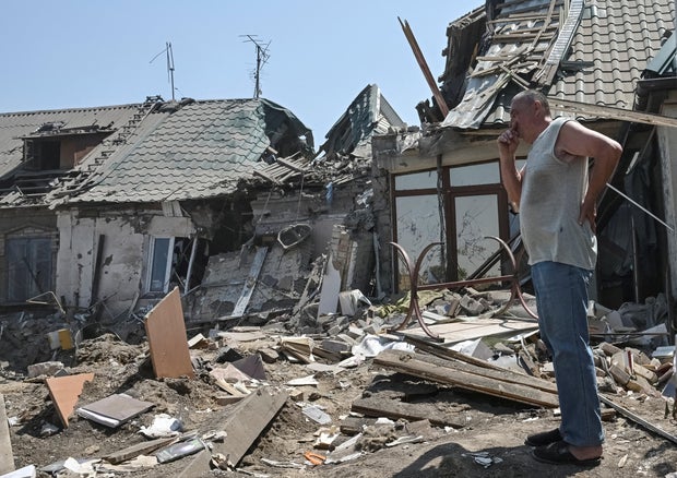 A resident stands at the site of a Russian air strike, amid Russia's ongoing full-scale invasion of Ukraine, in Zaporizhzhia, Ukraine, June 9, 2025