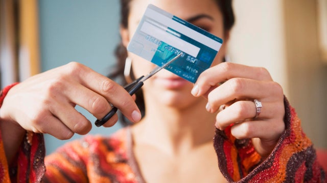 Woman cutting up credit card 