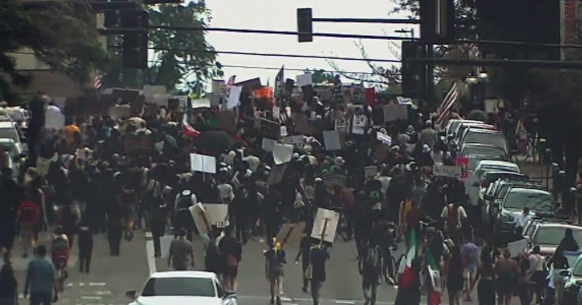 Rallyers in Denver demonstrating against ICE arrests march down the ...