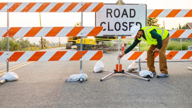 Hispanic Workers Setting Barriers and Directing Traffic Street Road and Highway Construction Photo Series 