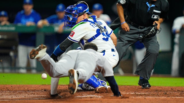 Pablo Reyes #19 of the New York Yankees slides into home to score a run against Freddy Fermin #34 of the Kansas City Royals during the eighth inning at Kauffman Stadium on June 12, 2025 in Kansas City, Missouri. 