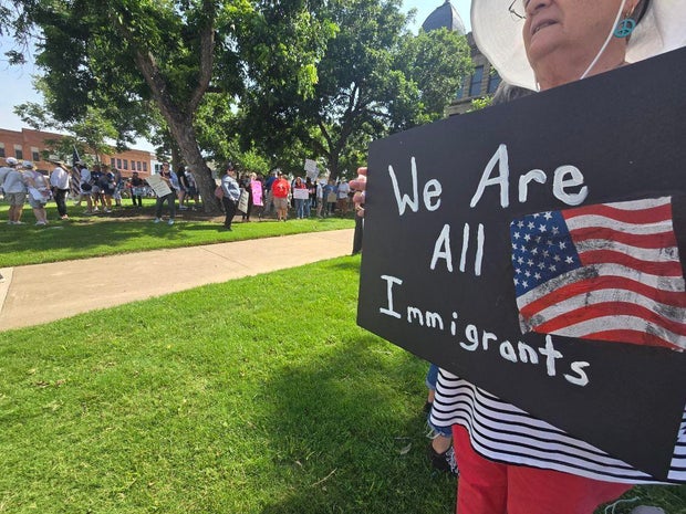 Woman holds a sign at