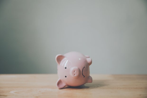 Piggy bank on wood table. Financial investment and save money concept 