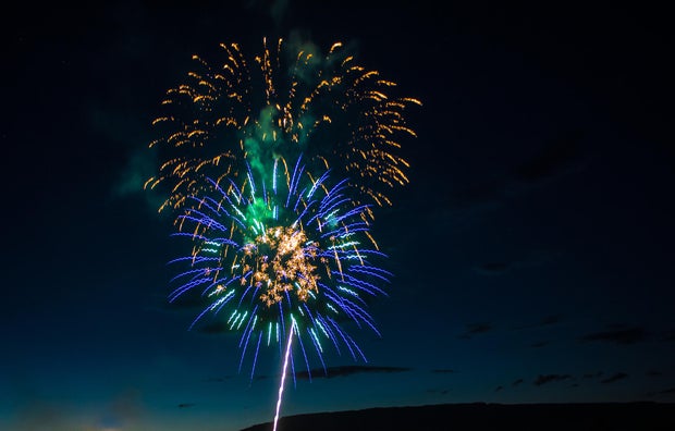 Independence Day 4th of July fireworks with the Grand Mesa in the background near Delta, Colorado