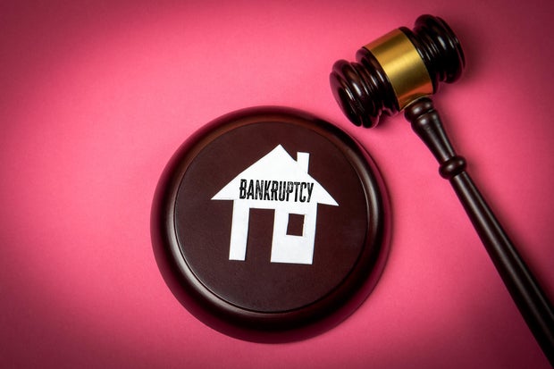 Bankruptcy Legal Concept with House Icon and Judge Gavel on Pink Background
