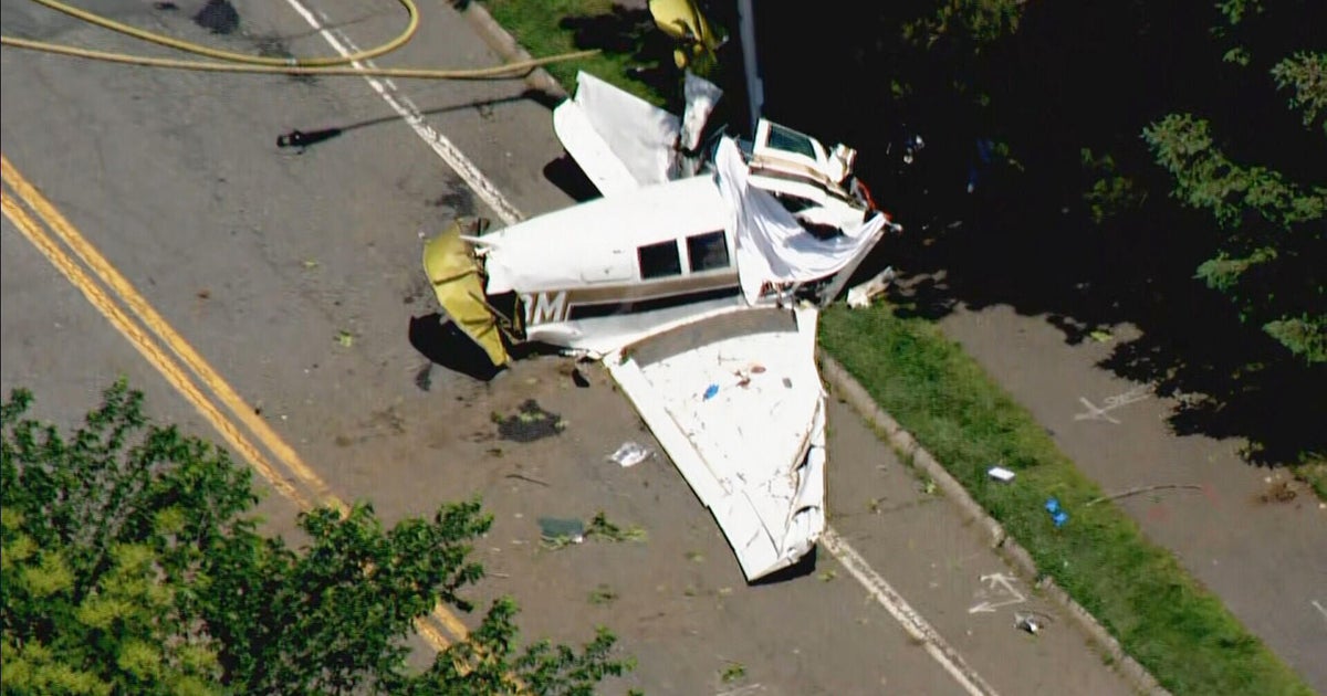 One dead after small plane crashes on street near Beverly Airport 