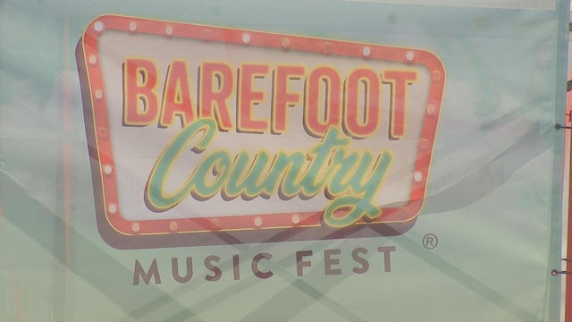 A sign with the logo for the Barefoot Country Music Festival 