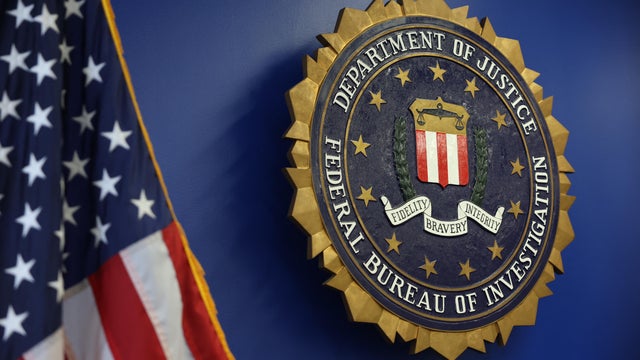 The FBI seal and a U.S. flag 