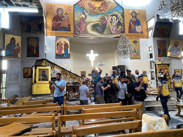 People and civil defence members inspect the damage after a blast rocked the Mar Elias Church in the Dweila neighbourhood of Damascus 