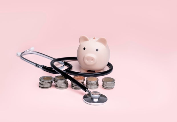 Piggy bank with coins and a stethoscope,Health insurance and savings concept,Health and money,Savings and pet insurance,Health insurance,Pet health insurance 