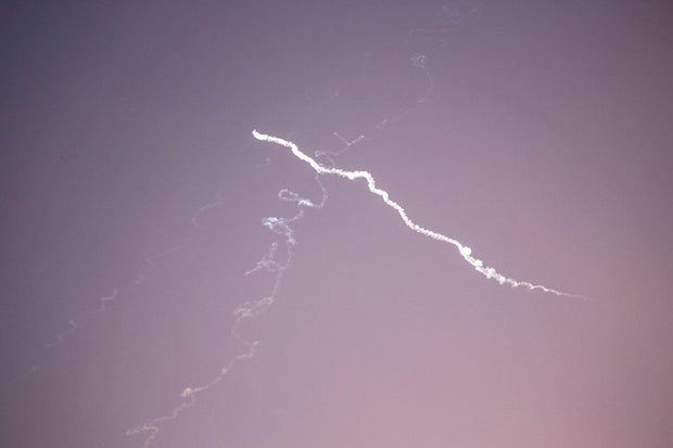 Iranian missiles aimed at targets in Israel pass over the 