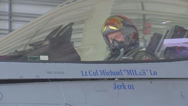 A pilot prepares for a flight in a fighter jet 