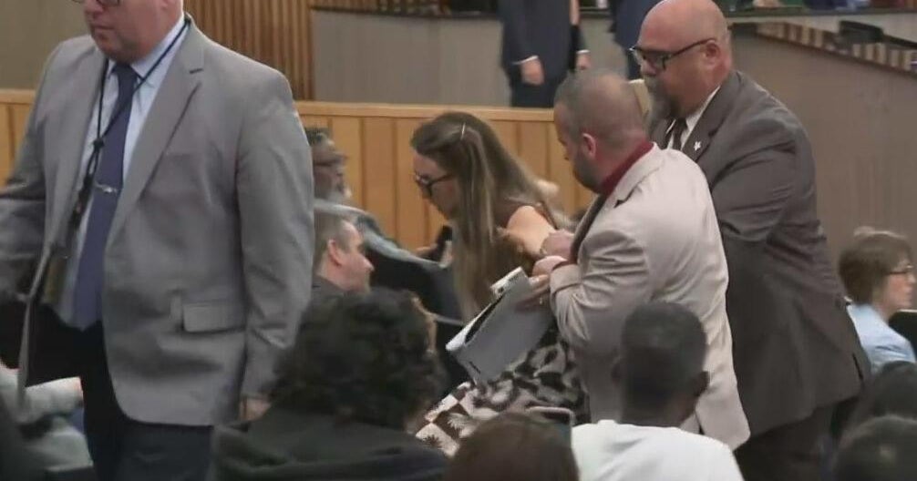 Woman protesting Miami-Dade cooperation with ICE dragged out of commission meeting