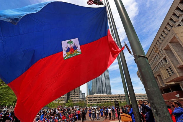 A speaker addresses the crowd during a Haitian Flag Raising Ceremony in Boston on May 17, 2024. 