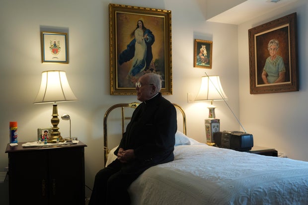 The Rev. James Kelly sits in his apartment in the Normandy Farms Estates retirement community in Blue Bell 