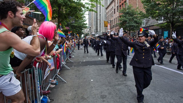 In this June 30, 2013 file photo, members of the Gay Officers Action League of the New York police department are cheered during the gay pride march in New York. 