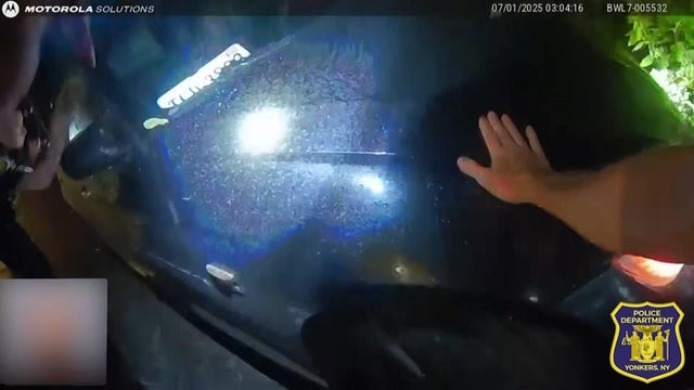 Body cam video shows a Yonkers Police officer with his hand on the hood of a vehicle. 