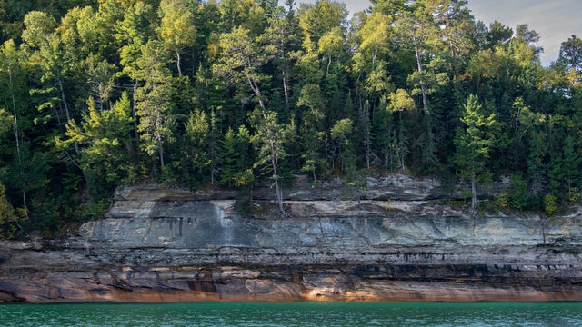 Munising, Michigan, Pictured Rocks National Lakeshore on Lake Superior in the Upper Peninsula of Michigan. The colors in the cliffs are created by the large amounts of minerals in the rock. 